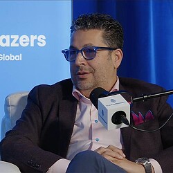 A man sitting at a microphone.