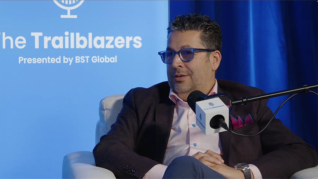 A man sitting at a microphone.