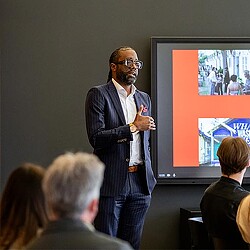 A person speaking to a group of people.