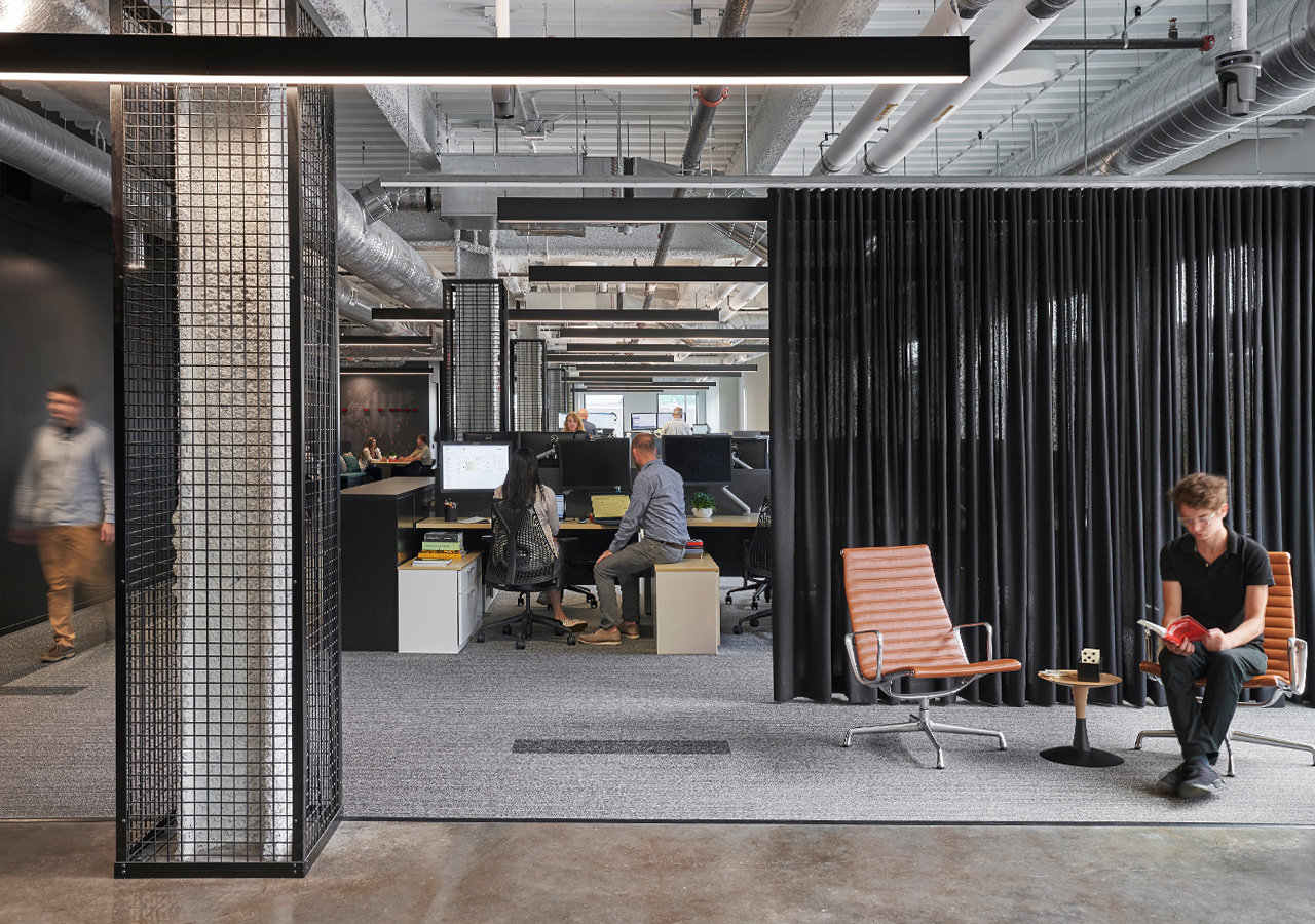 A few people sitting at a desk.