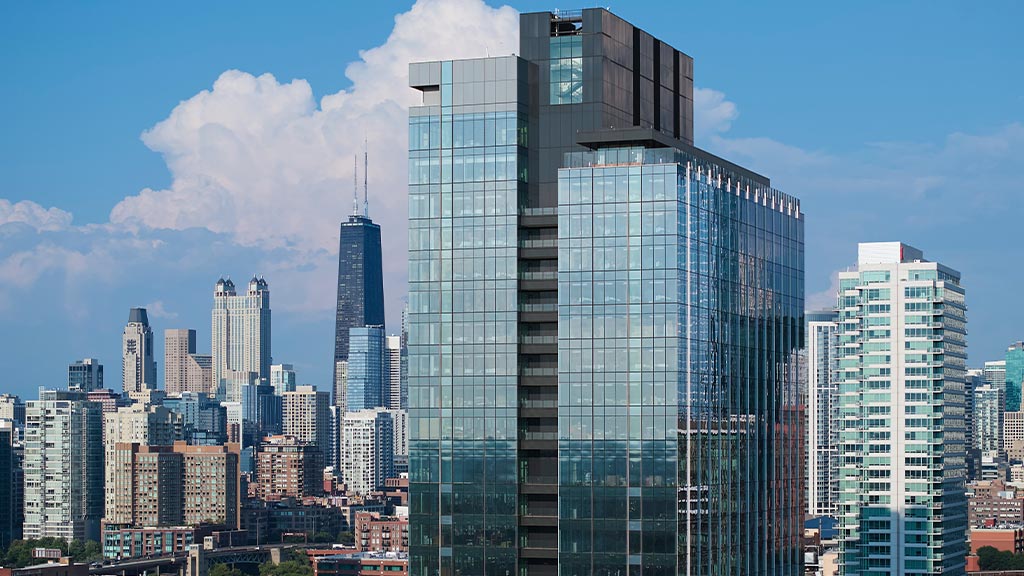 A tall glass building in a city.