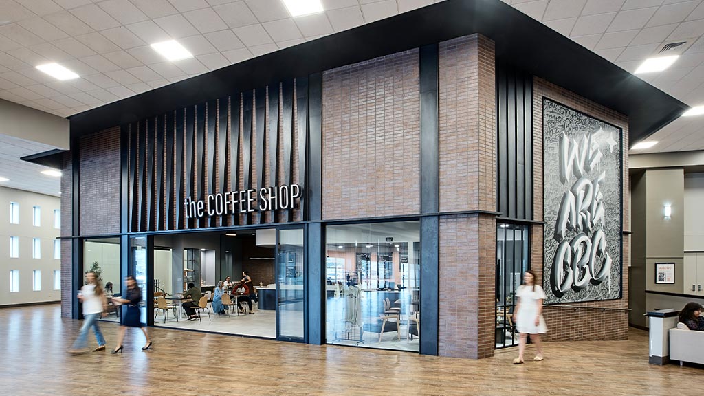 A group of people walking in a building.