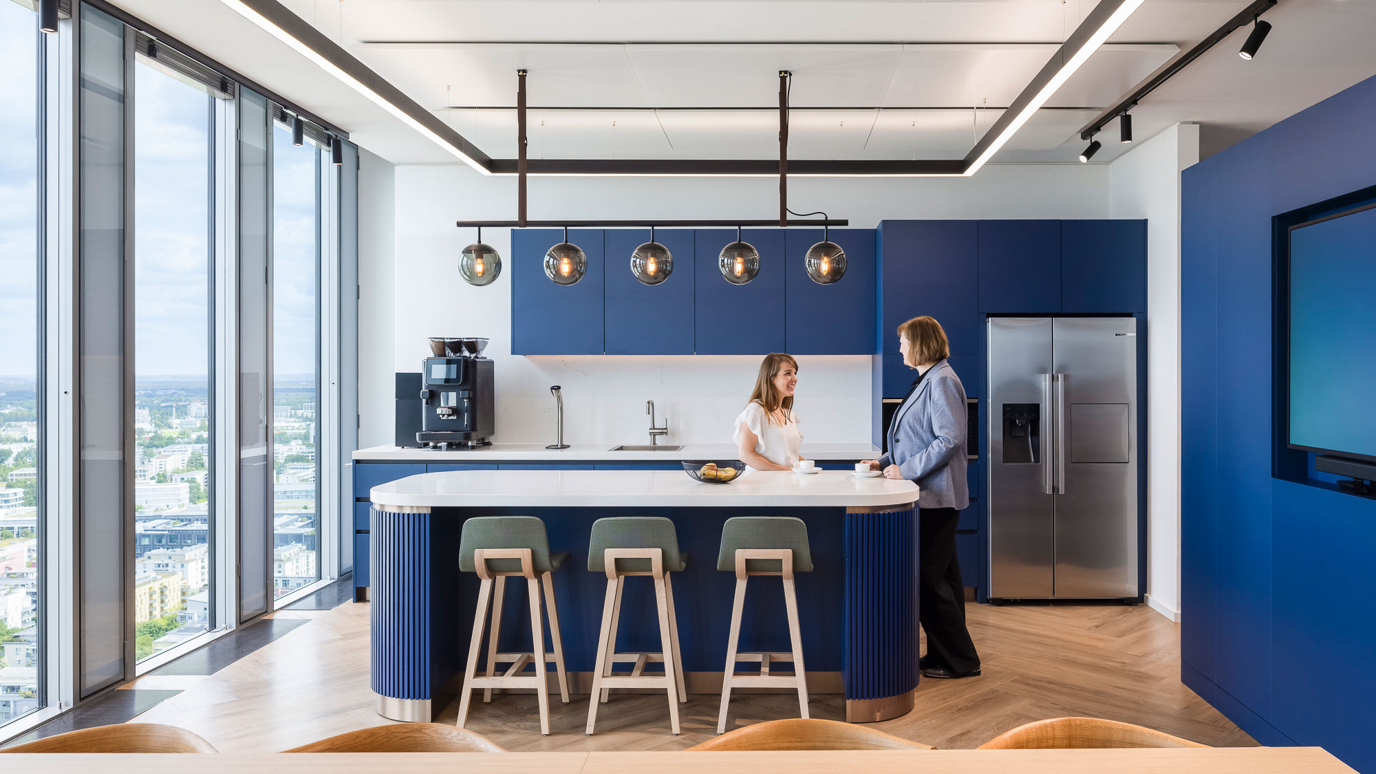 A couple of women in a kitchen.