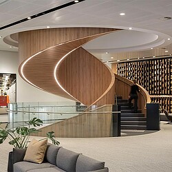 A staircase with a wood railing.