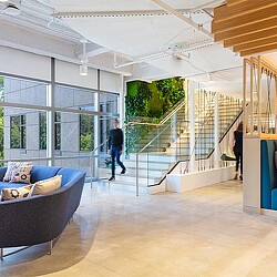 A couple of people walking up a staircase.