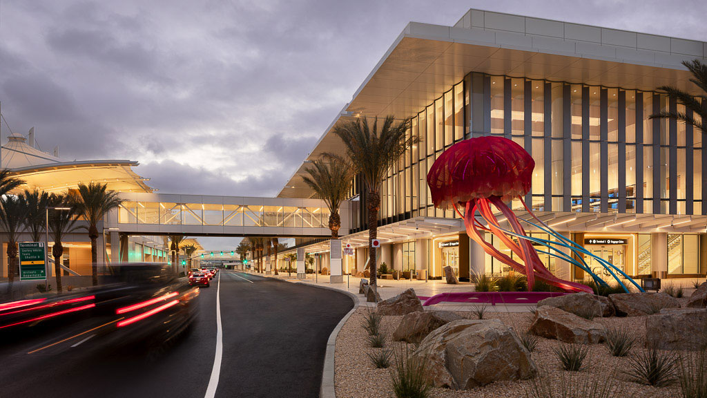 A building with a large red sculpture.