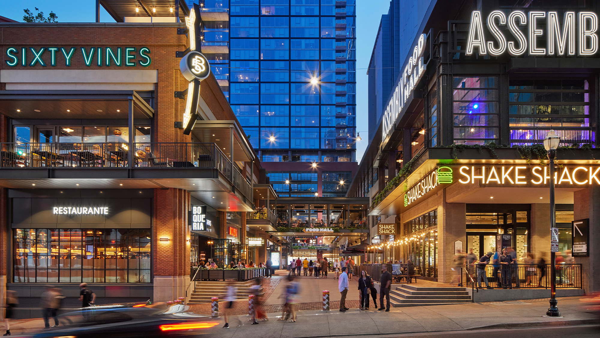A street with people and buildings on either side of it.