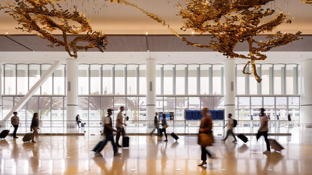 A group of people walking in a large building.