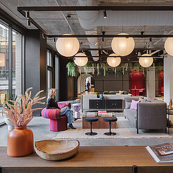 A couple of people sitting on a couch in a room with a large chandelier and a.