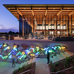 A building with a pool and people.