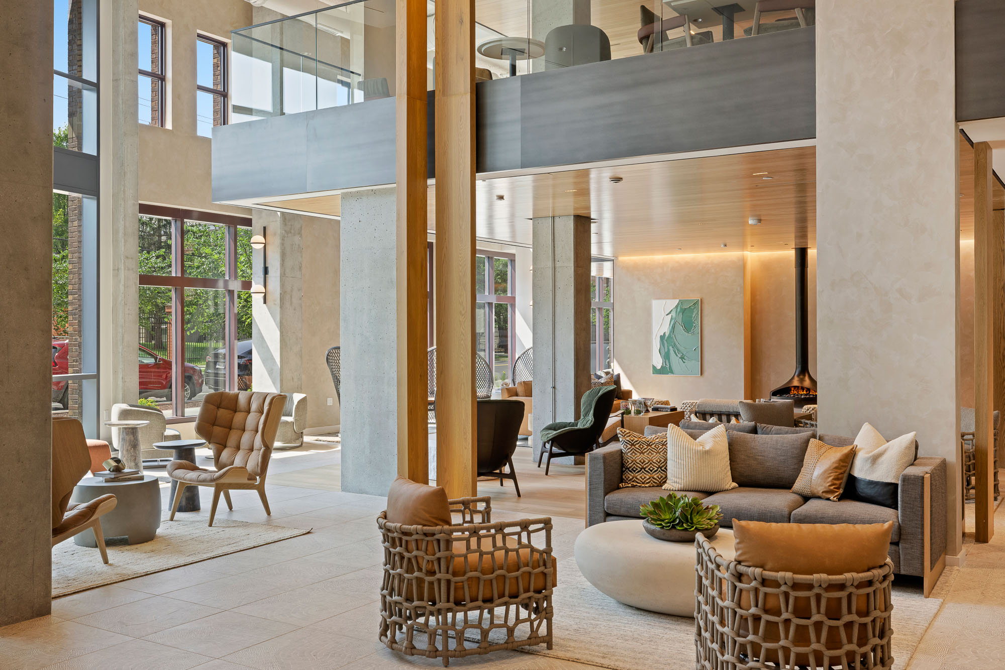 A room with a couch and chairs.