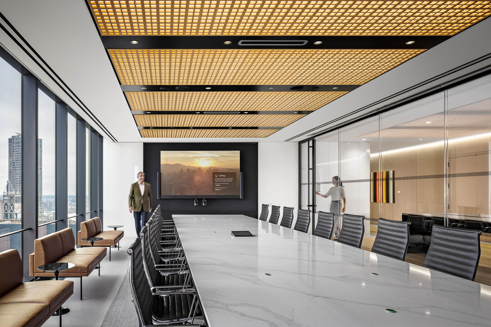 A large room with a large screen and chairs.