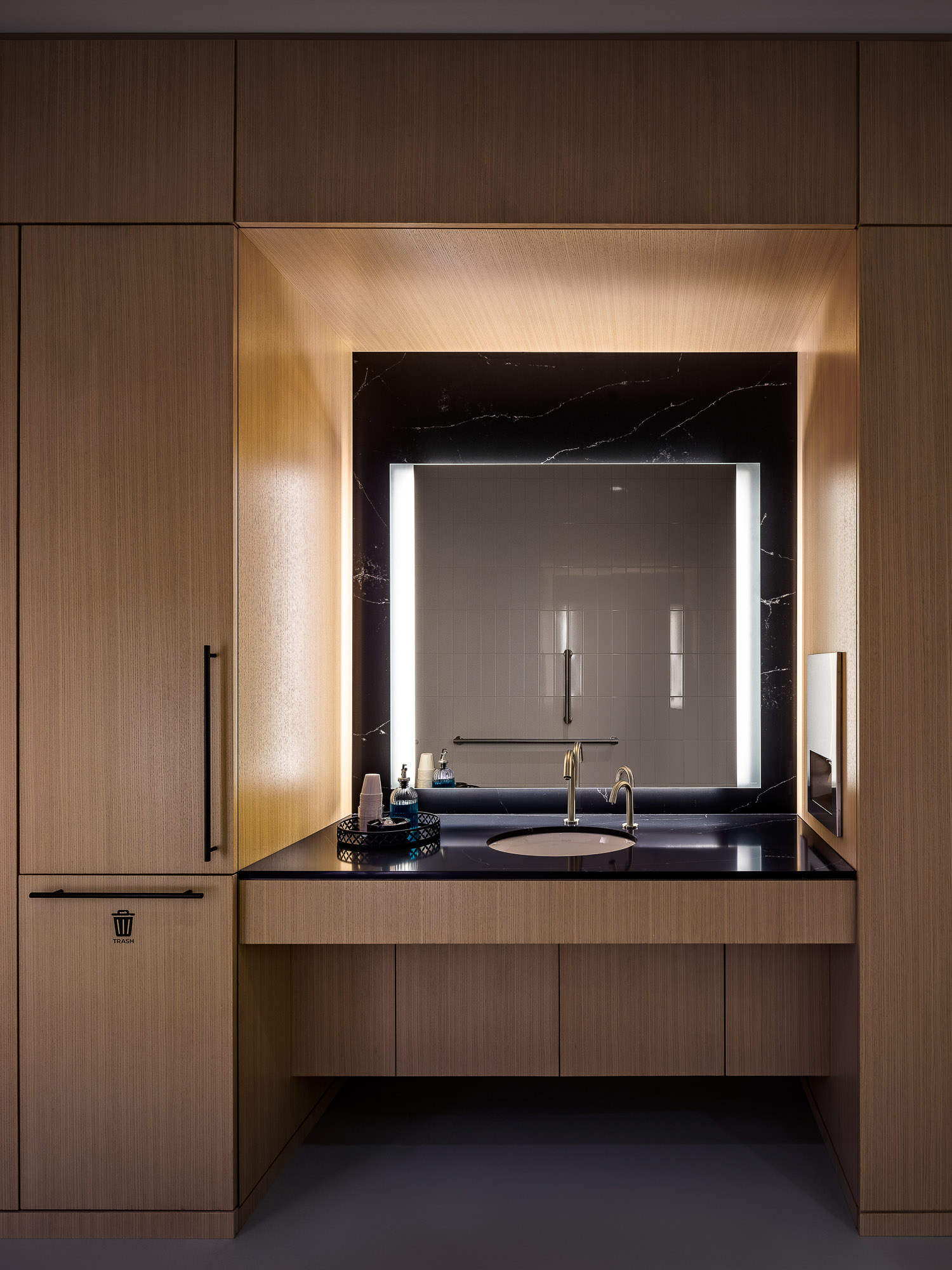 A bathroom with a large mirror.
