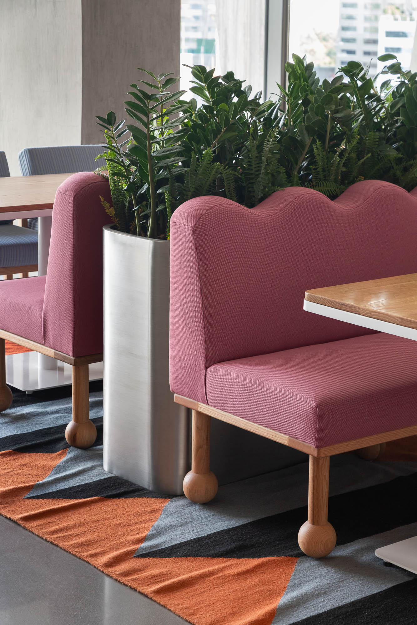 A pink chair with a plant on it.