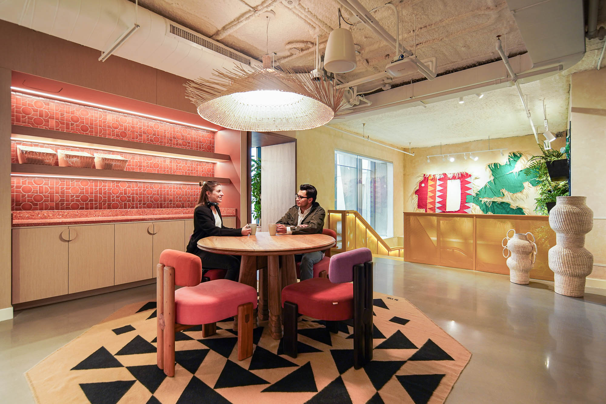 A man and woman sitting at a table in a restaurant.