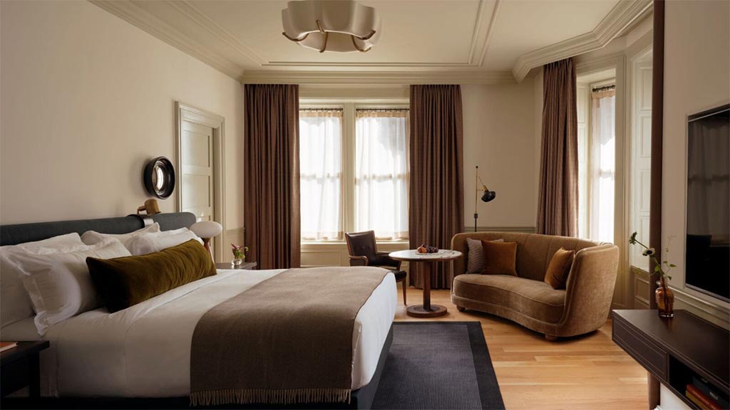 A bedroom with a bed and couch.