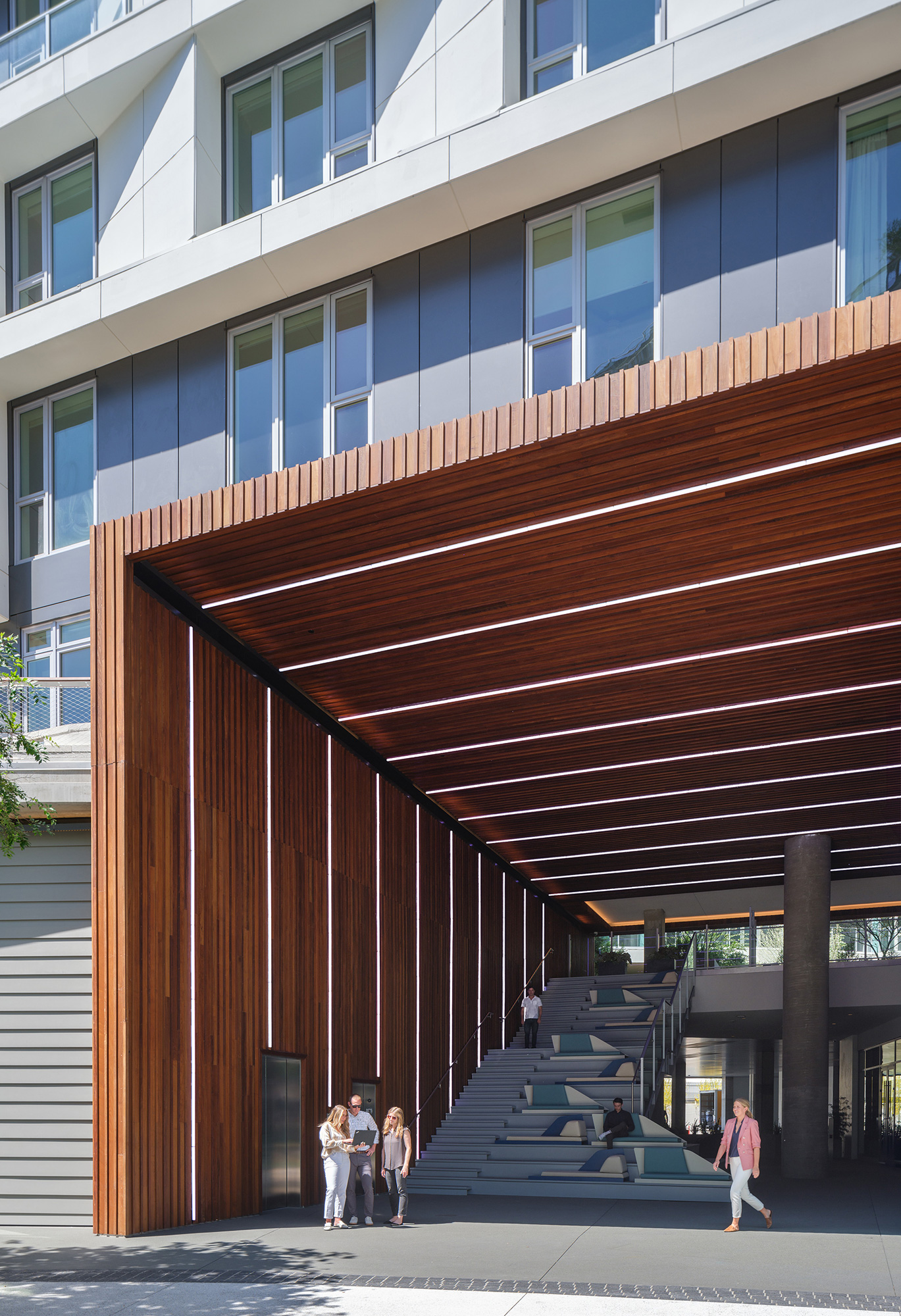 People walking up stairs to a building.