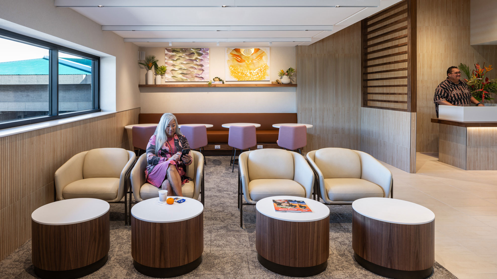 A man and woman sitting in a room with a table and chairs.