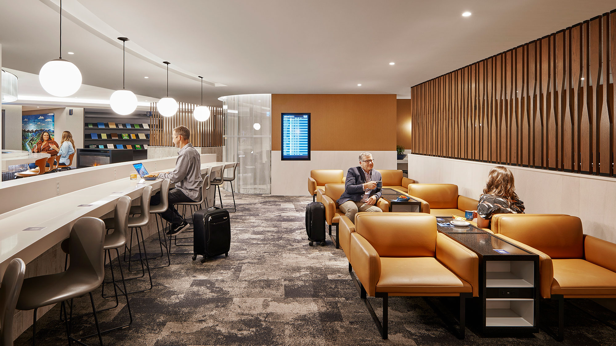 A group of people sitting in a room with tables and chairs.