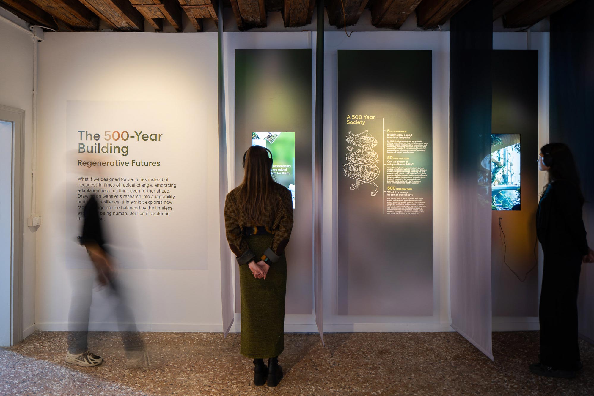 A person standing in front of a sign.