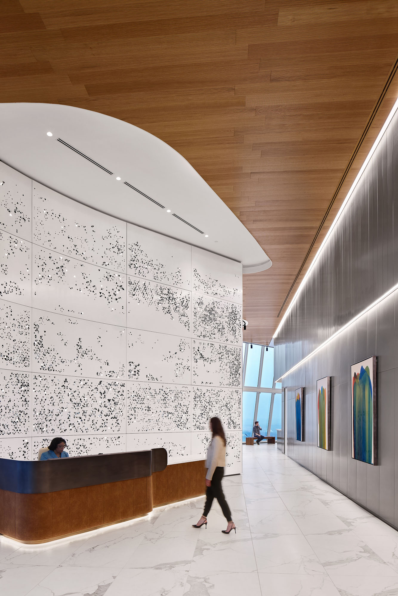 A man looking at a wall of art.