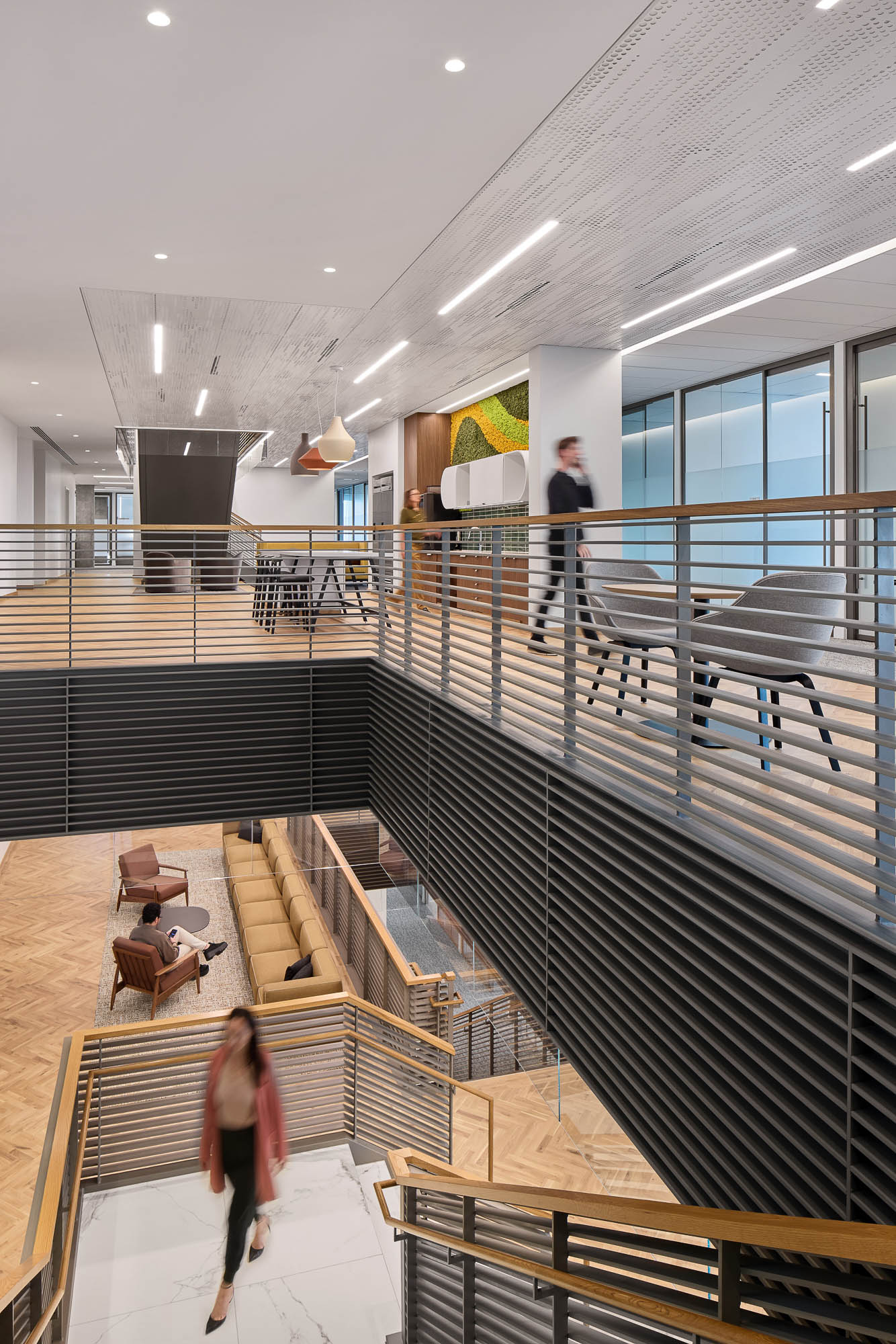 A man and woman walking down a flight of stairs.