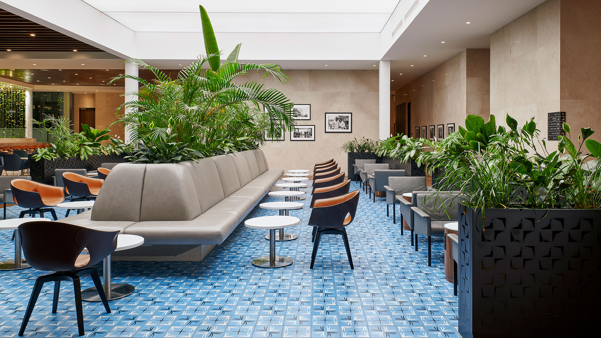 A room with a couch and chairs.