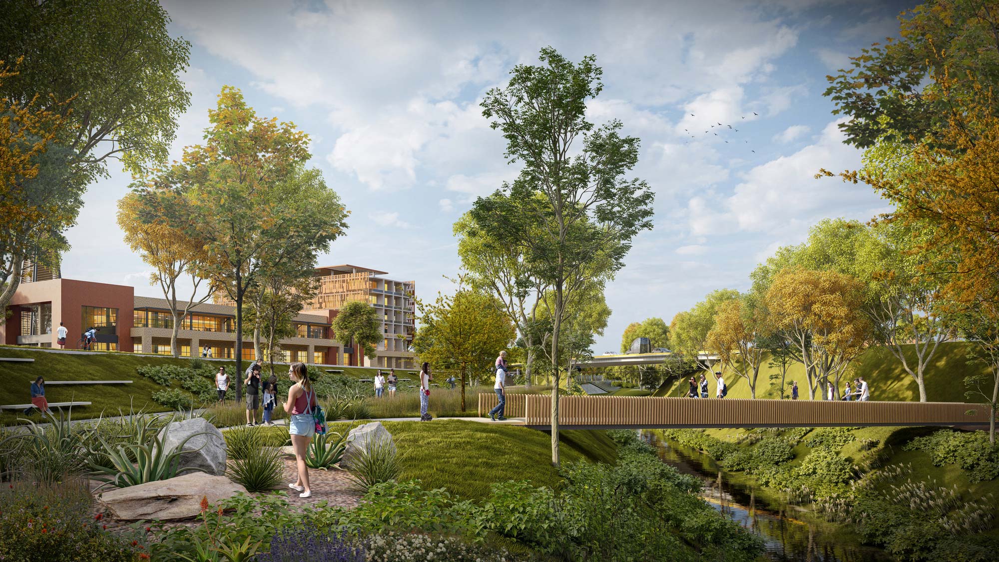 A group of people walking around a park with a bridge and buildings.