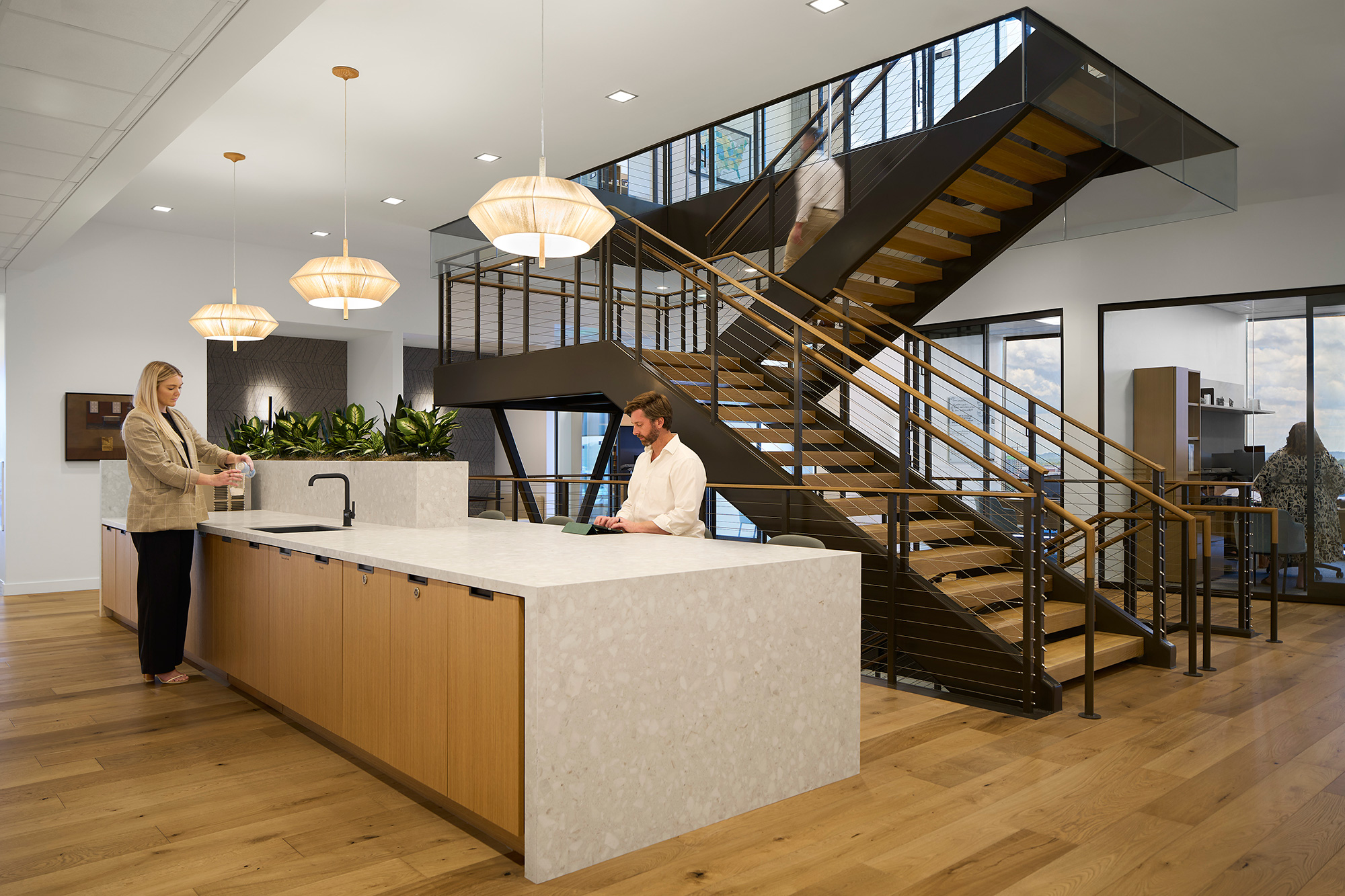A woman and a man in a kitchen.
