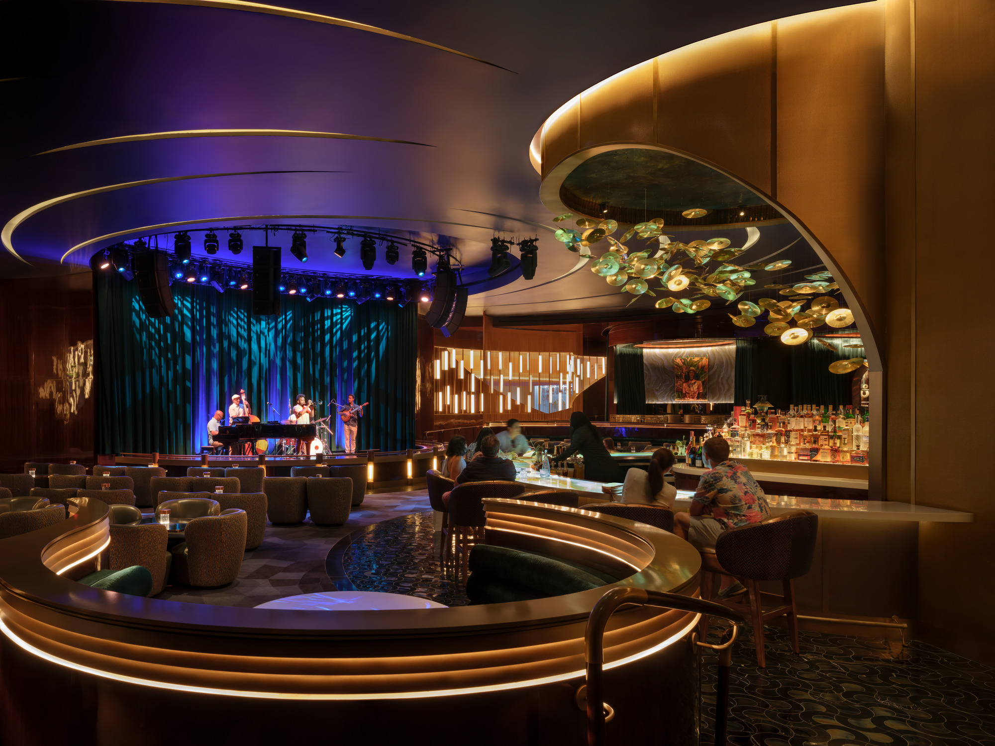 A group of people sitting in a room with a large round table.