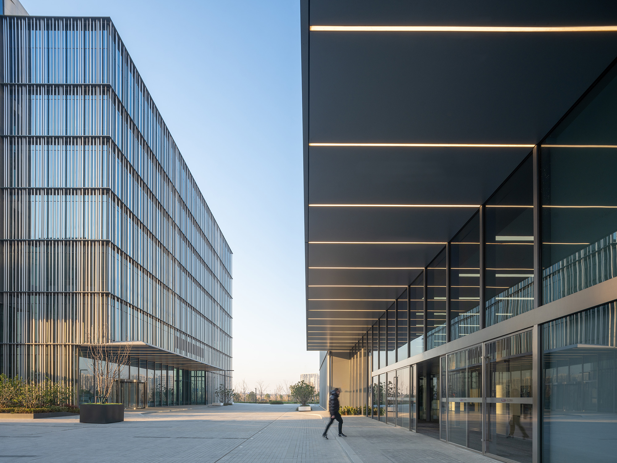 A person walking outside of a building.