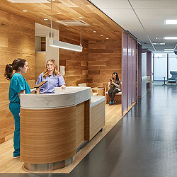 A person standing next to a counter.