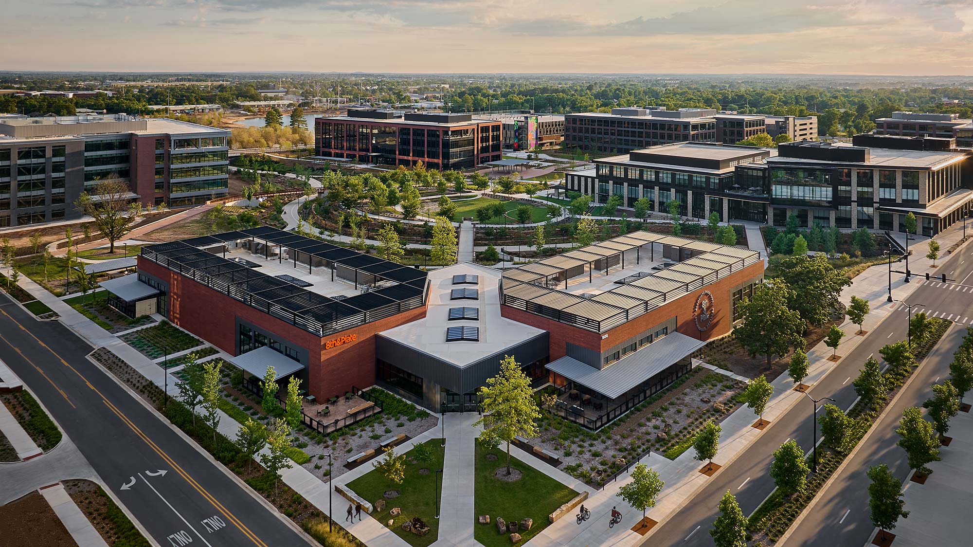 A large building with a courtyard and trees in front of it.