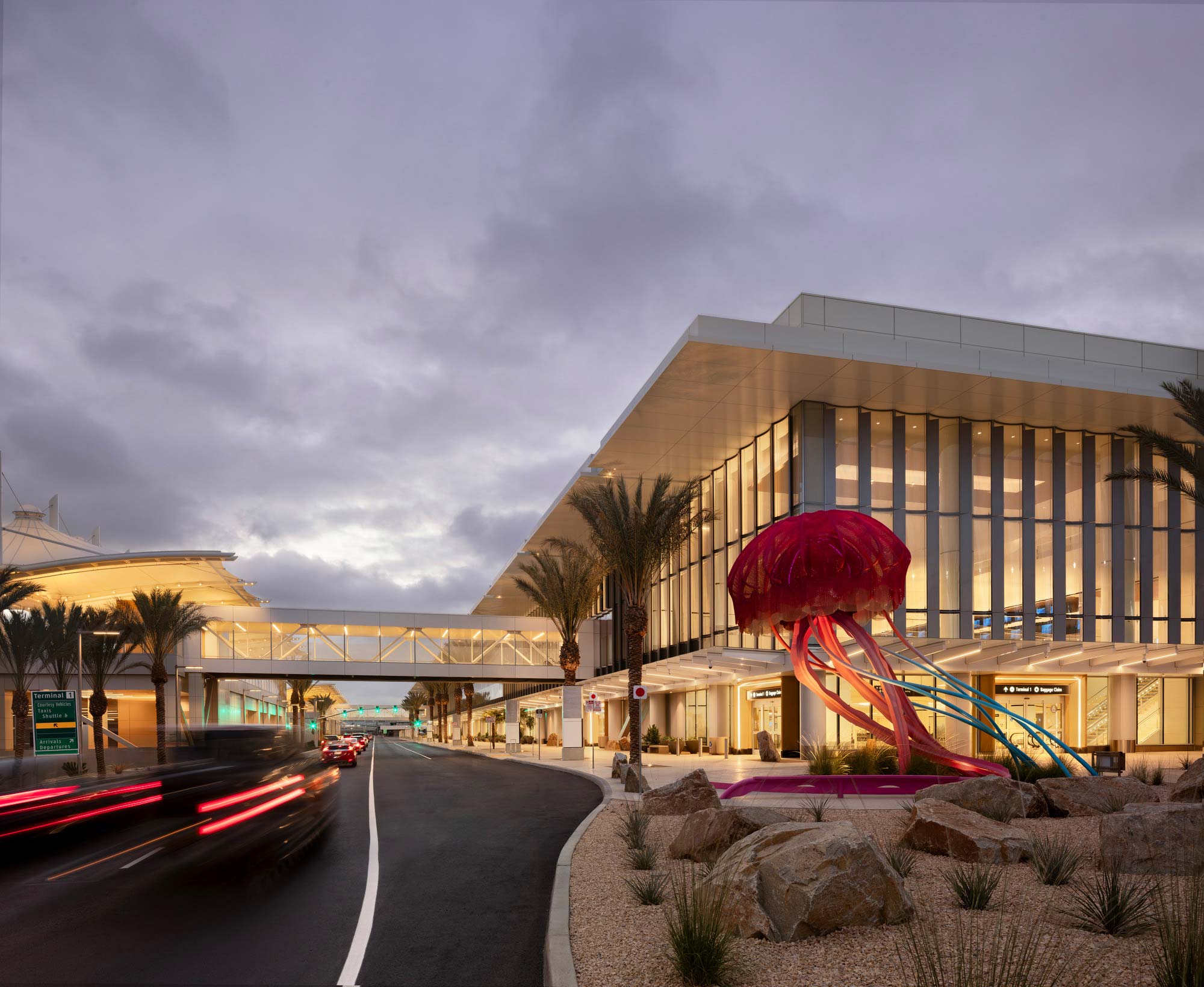 A road with a building and trees on the side.