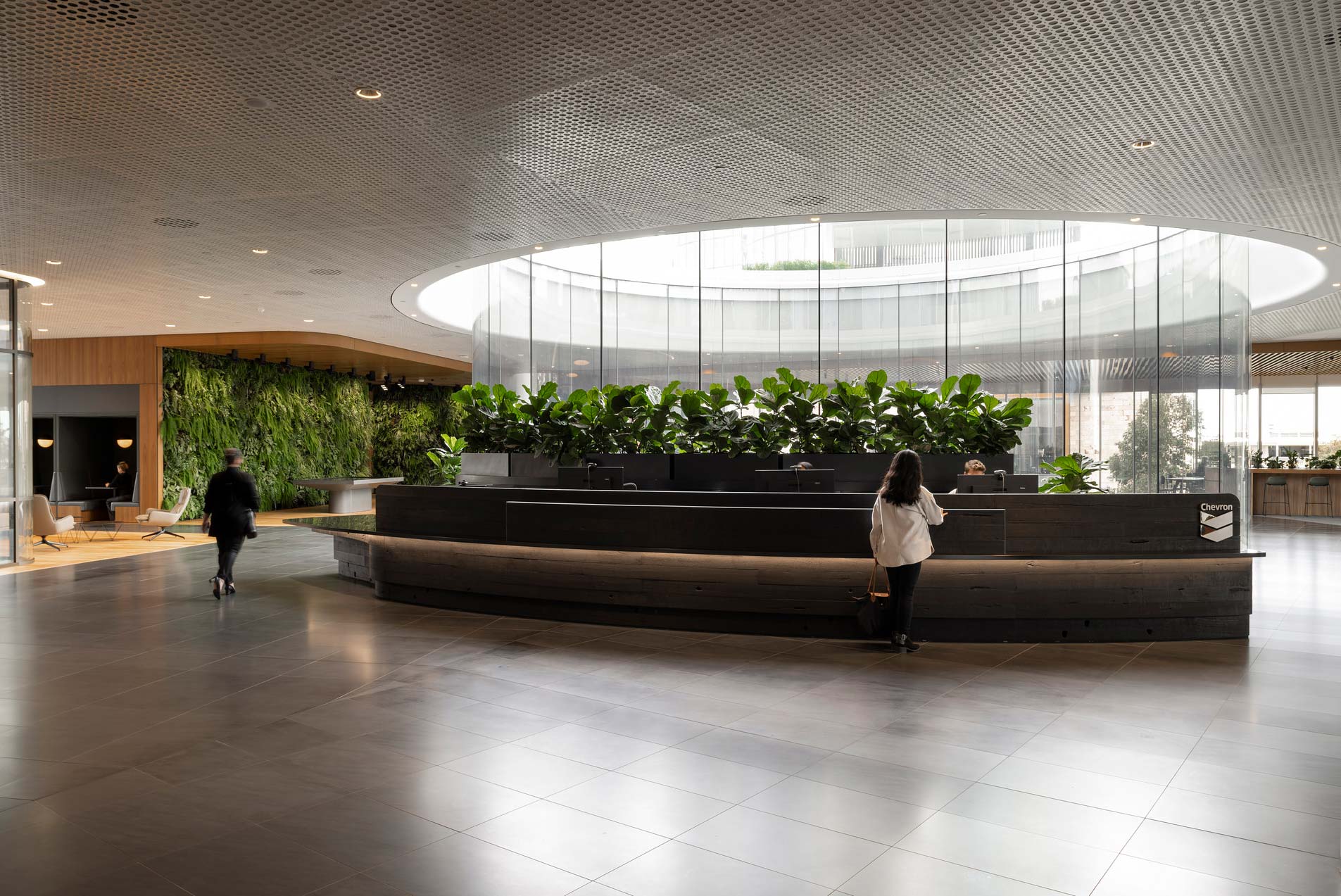 A couple of people walking in a large building.