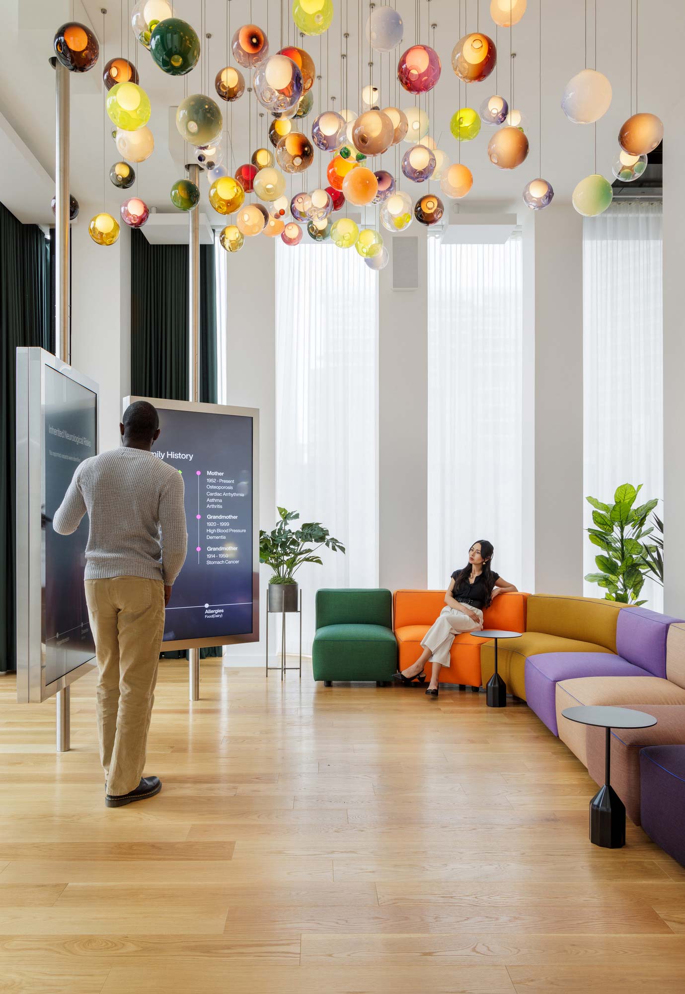 A man and woman watching a television.