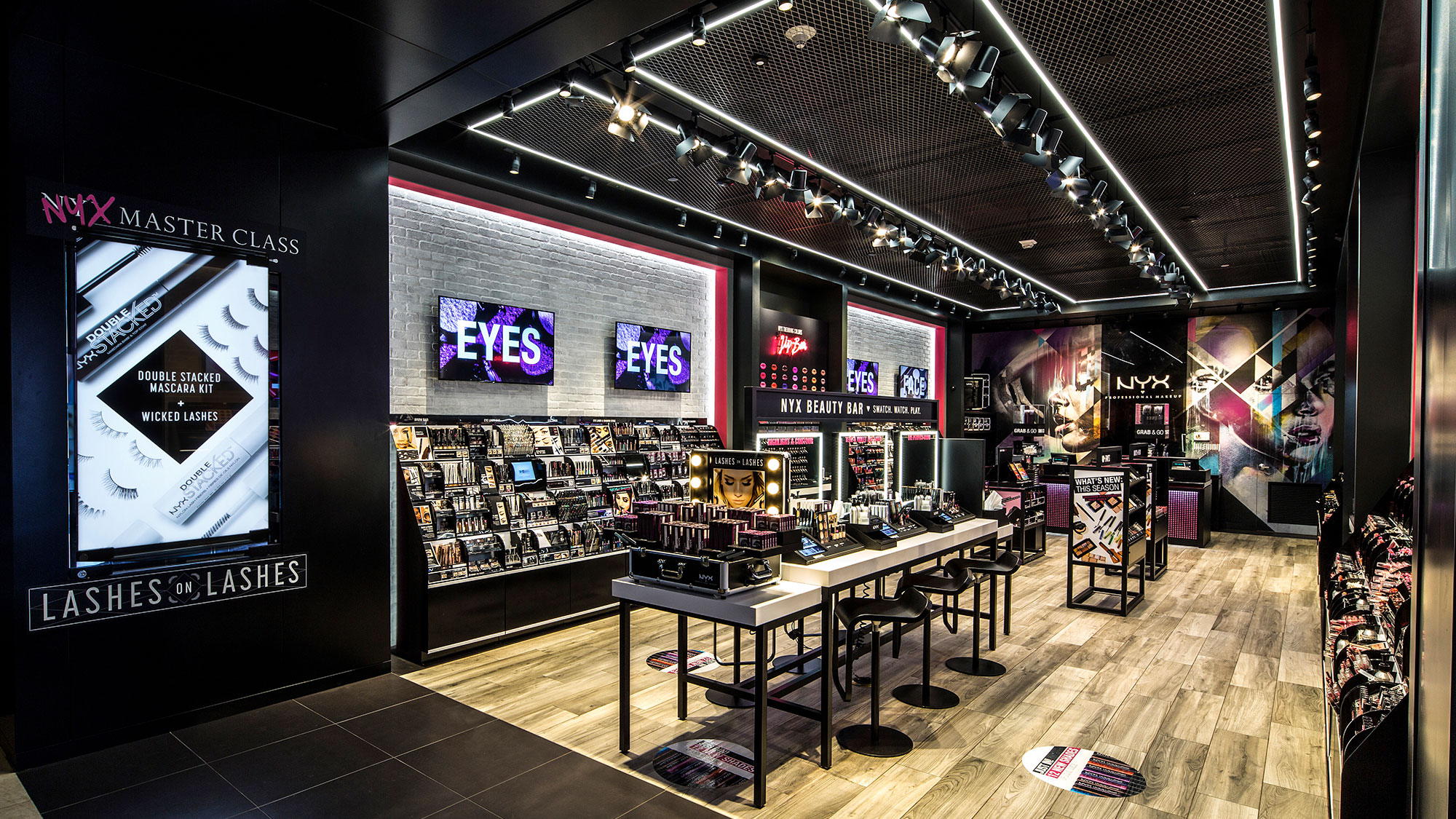 A room with a table and chairs and screens.