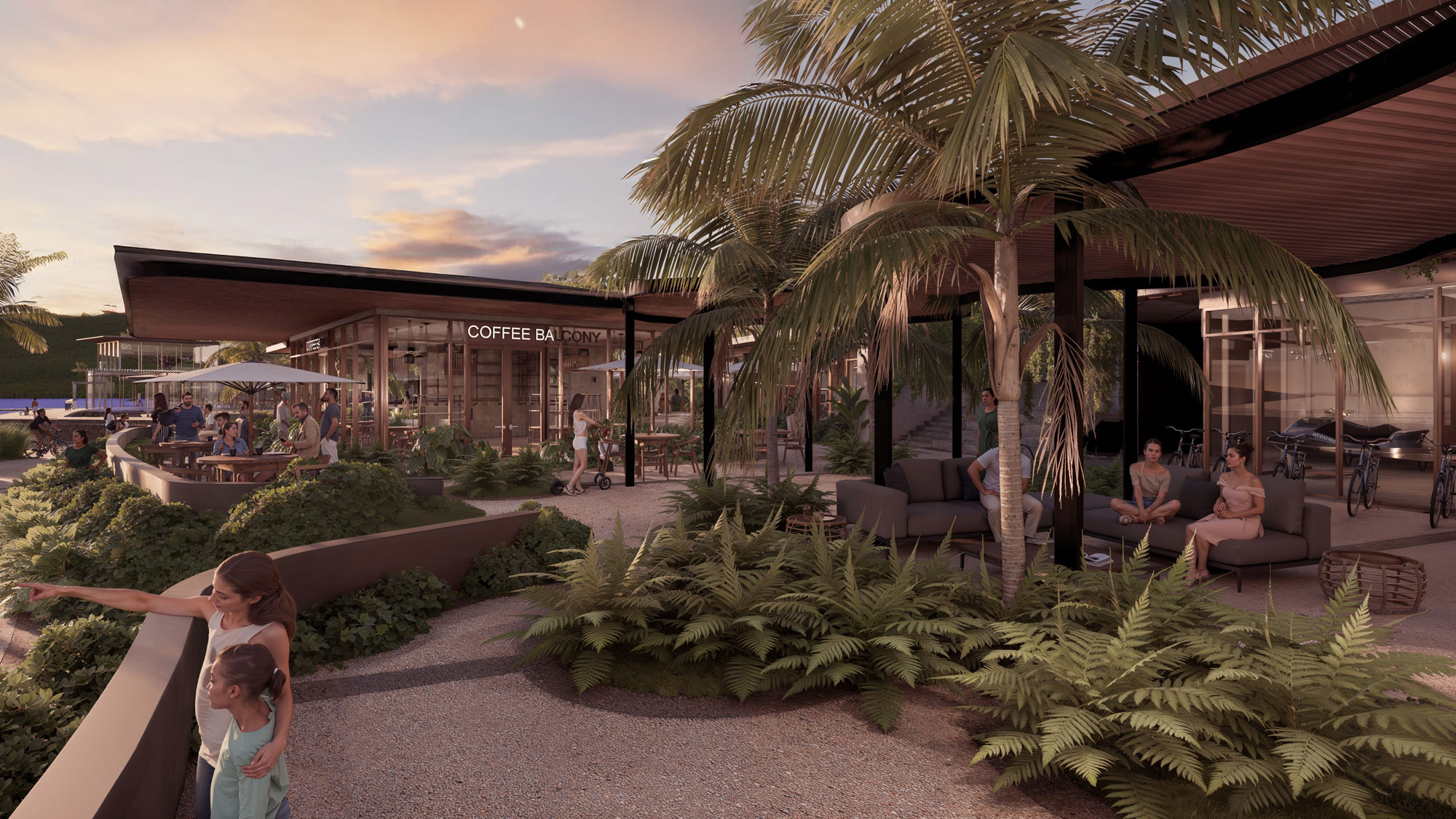 A group of people sitting on a lounge chair in a tropical area.