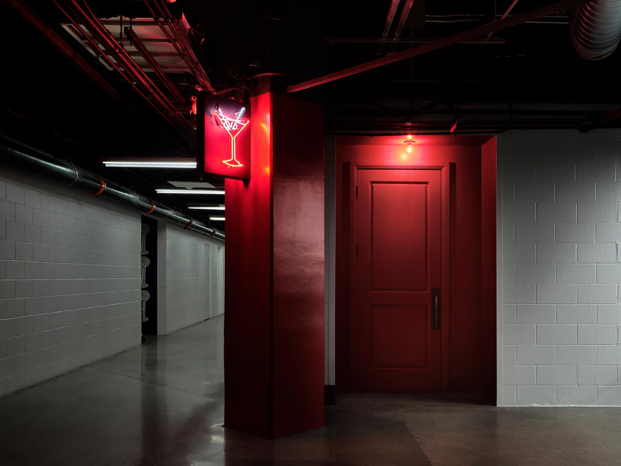A hallway with red doors.