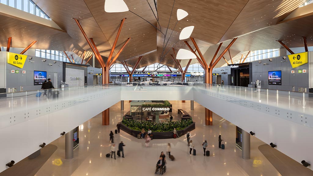 A large room with people and signs.