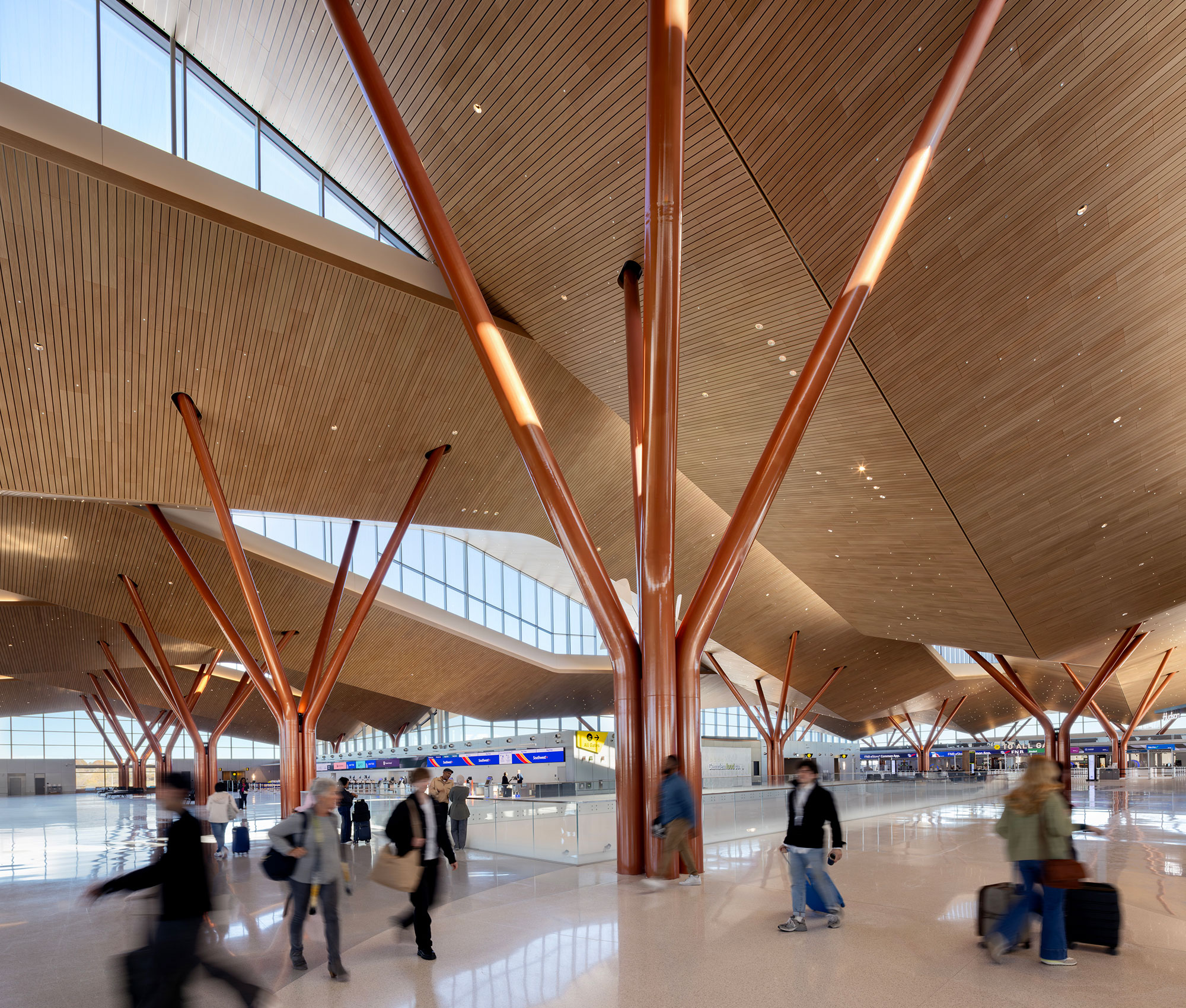 A group of people walking in a large building.