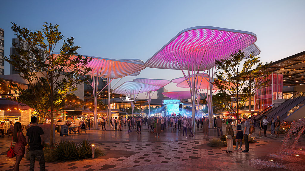 A group of people walking around a building with lights.