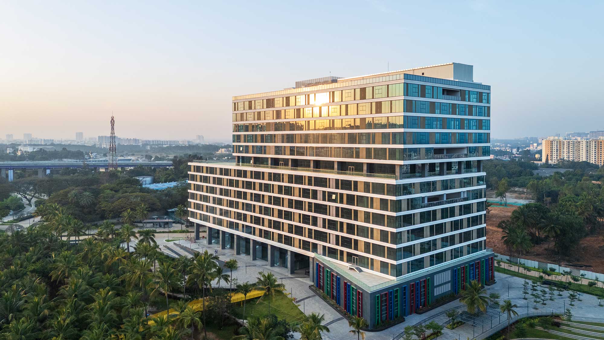 A building with a pool in front of it.