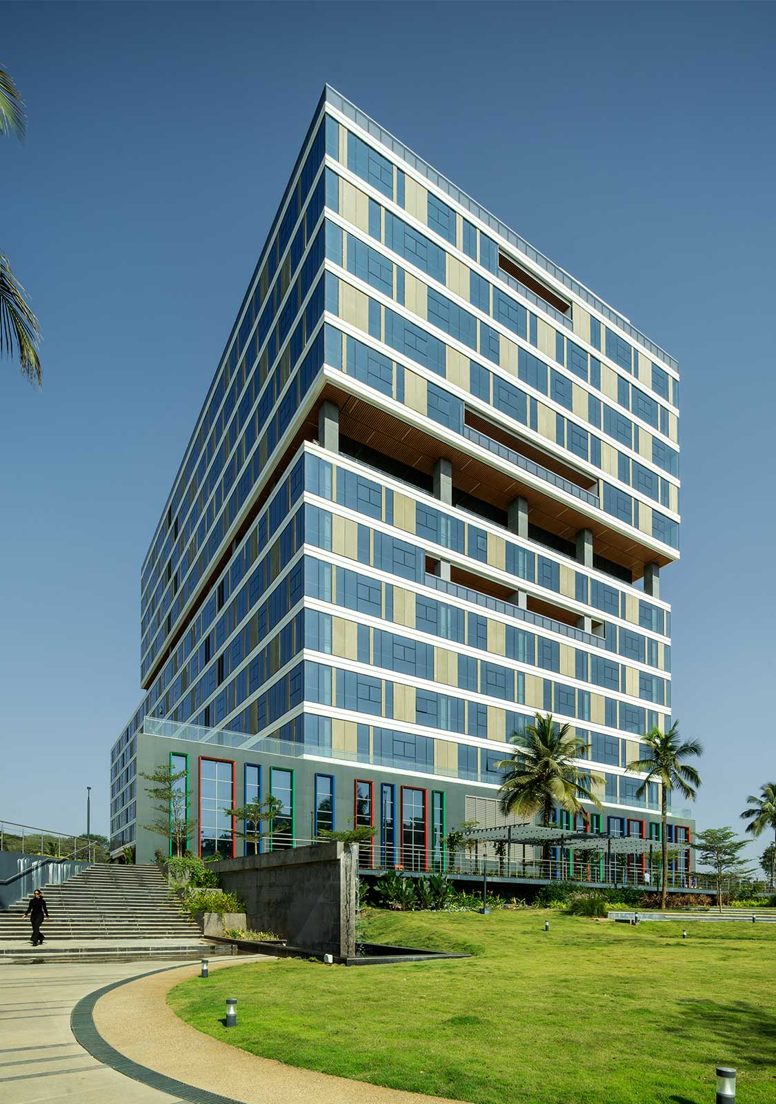 A building with a walkway and grass.