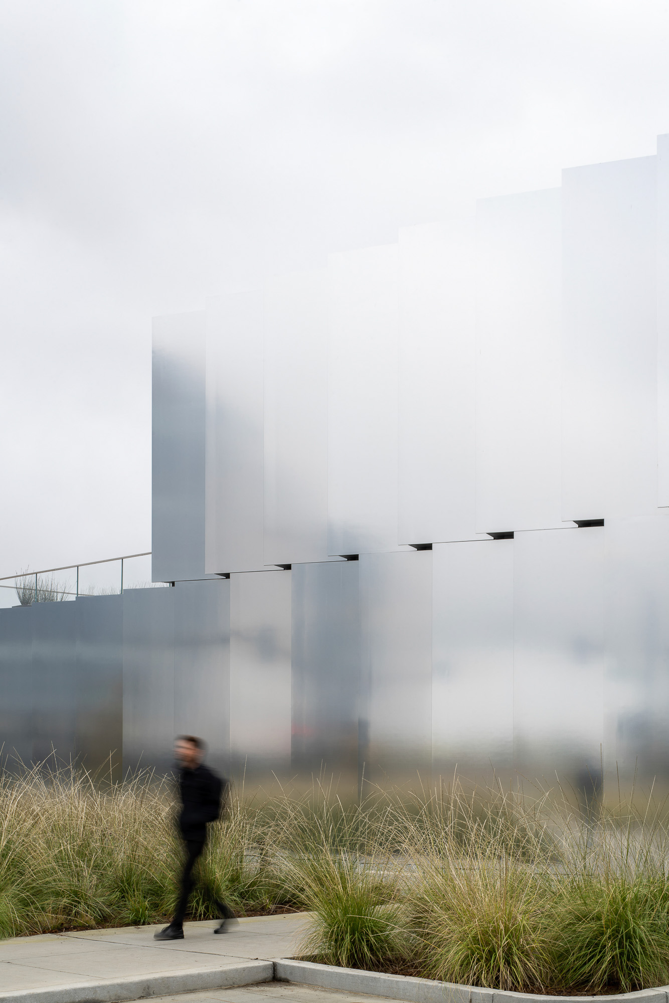 A person standing in front of a large building.