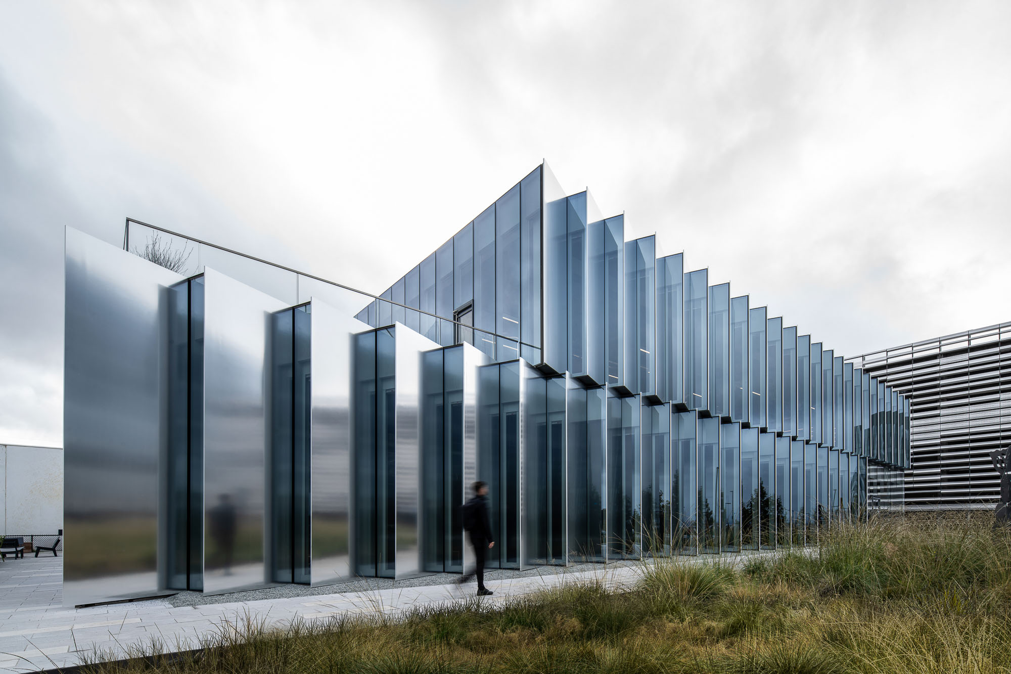 A person walking in front of a building.
