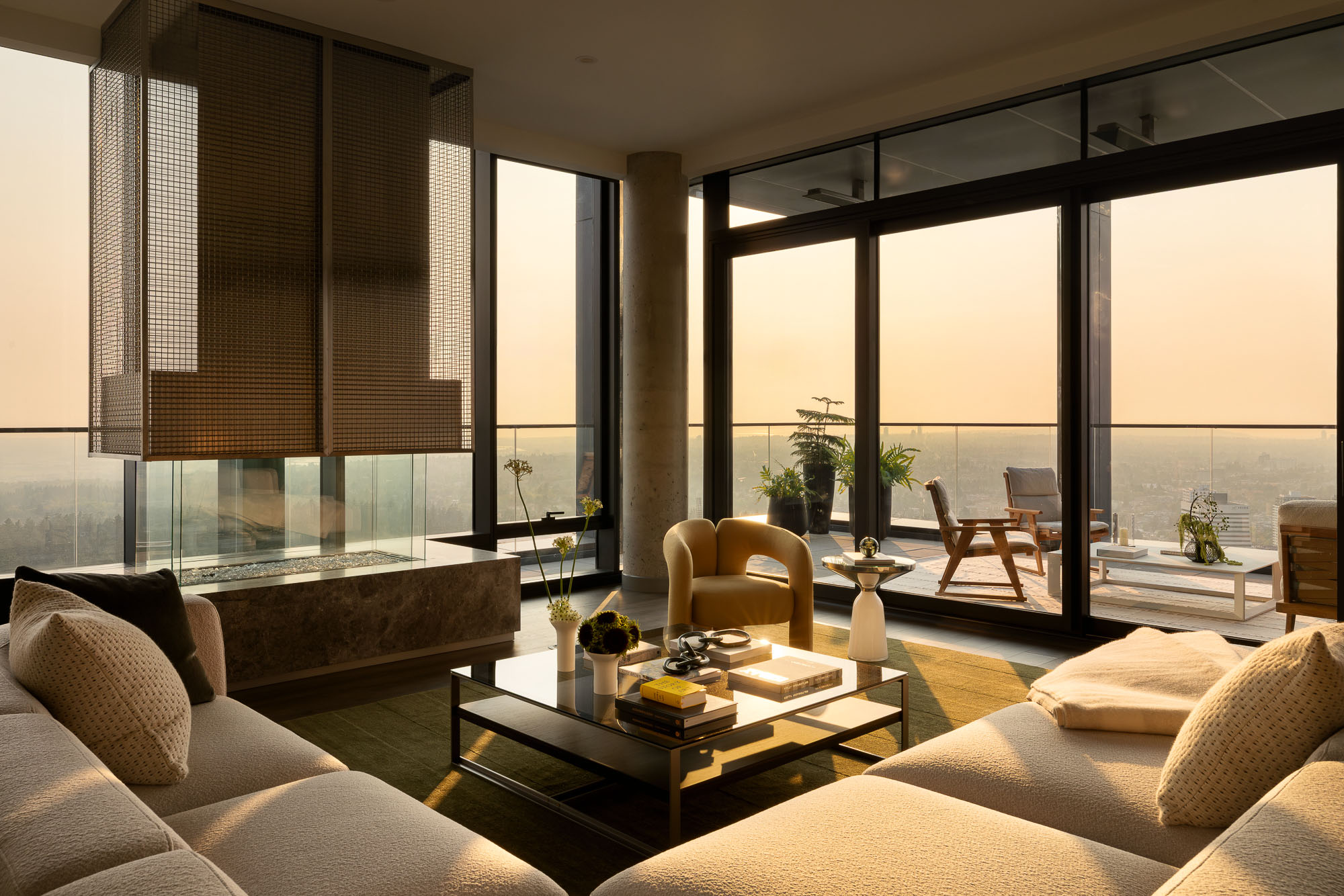 A room with a large window and a table with chairs and a couch.