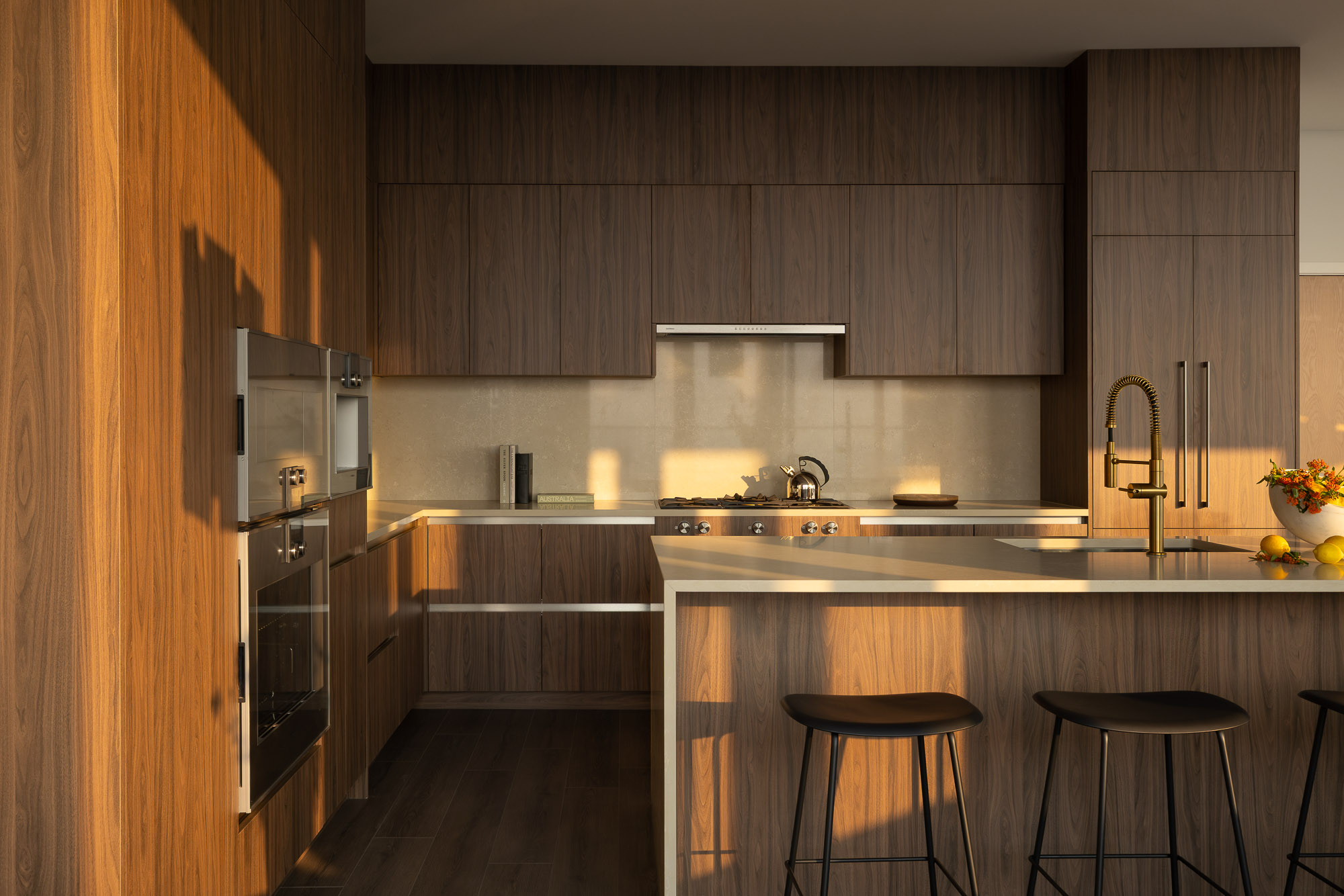 A kitchen with stools and a bar stool.
