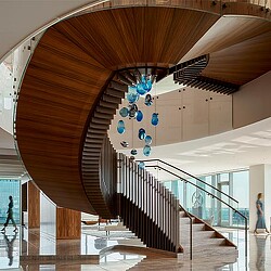 A staircase with blue and white balloons.