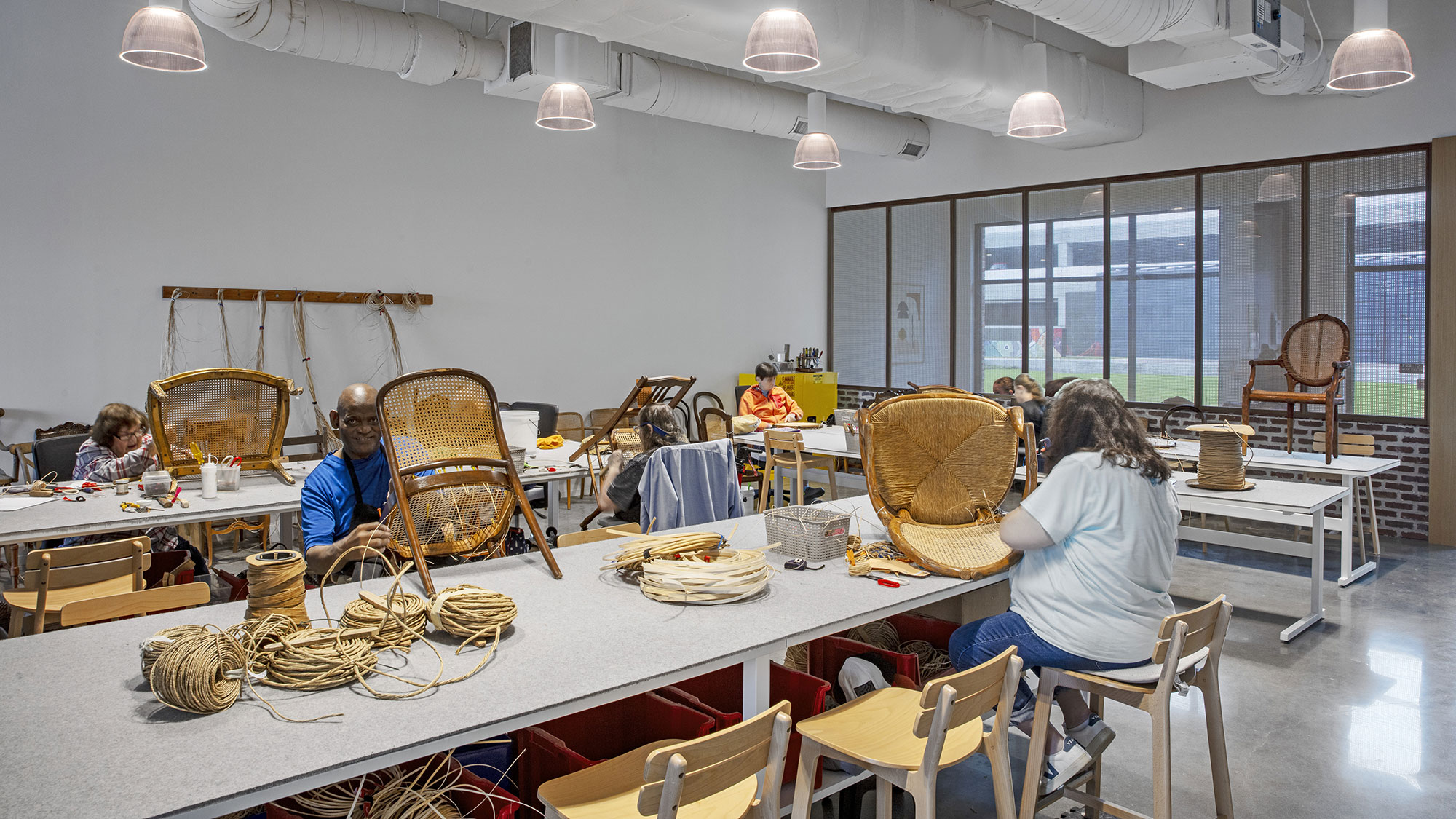 A group of people sitting at a table with baskets on it.